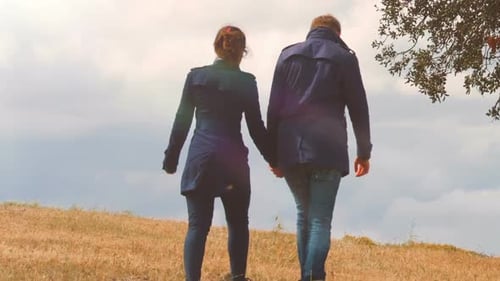 Beautiful Couple Holding Hands, Walking Together on Hill, Autumn Date Outdoors