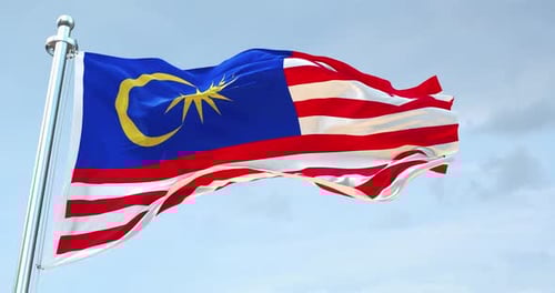 Malaysia Flag Waving Against Cloudy Sky