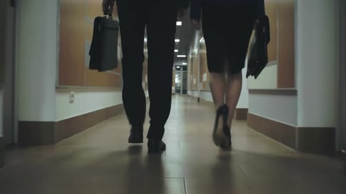 Business Colleagues Walking Down an Office Hallway