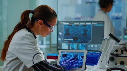 Scientist Using Digital Tablet Analysing Virus Evolution