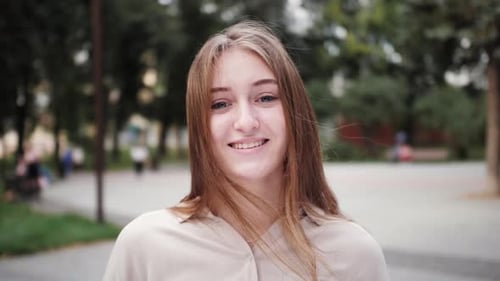 Smiling Woman in Urban Park Close Up