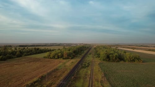 Railway Track Cuts Through Rural Landscape