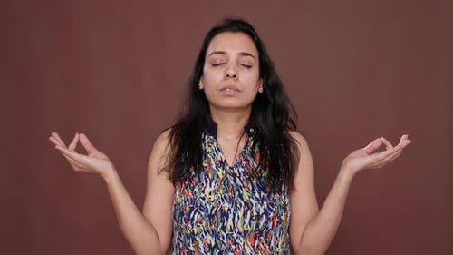 Portrait of Indian Peaceful Woman Doing Zen Meditation on Camera