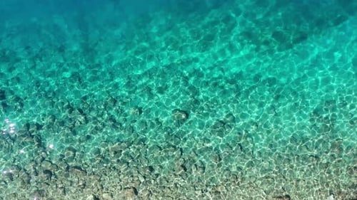 Waves and azure water as a background. View from drone at the sea surface.