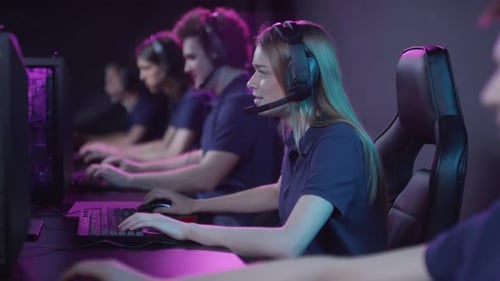 Young Adults Playing Video Games in Neon Gaming Room