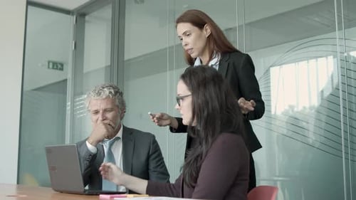 Team Collaboration on Laptop in Modern Office