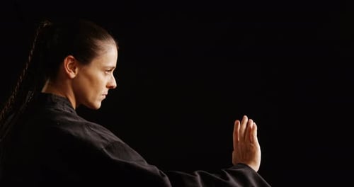 Woman Practices Martial Arts Punches and Blocks