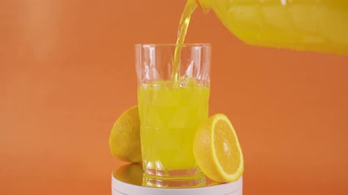 Juice Being Poured Into Glass with Ice