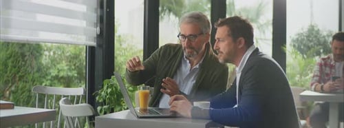 Business partners discussing in cafe