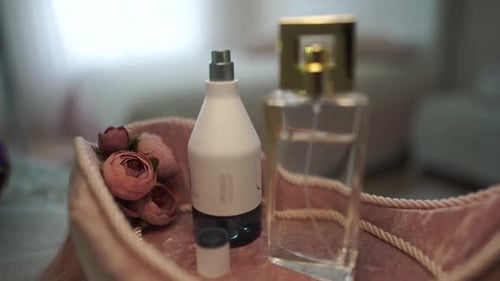 Perfume Bottles and Flowers on Pink Velvet Tray