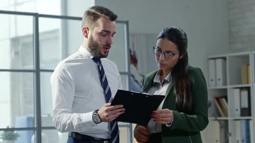 Business Colleagues Discussing Documents in Modern Office