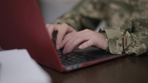 Female Hands in Camouflage Typing on Laptop Keyboard in Slow Motion