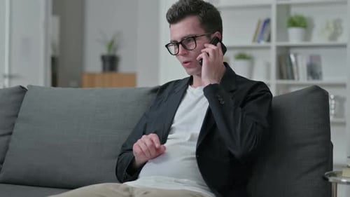 Young Adult Using Mobile Phone on Couch