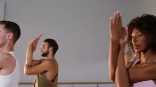 Group of people Practicing yoga in fitness studio