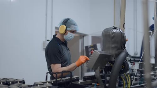 Factory Worker Operating Machines In A Beer Factory Medium Shot