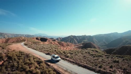 Aerial Shot of Camping Van on Gravel Mountain Road
