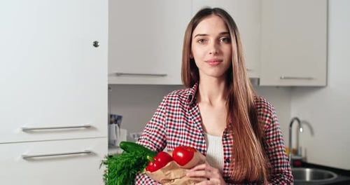 Woman Holding Pack of Vegetables