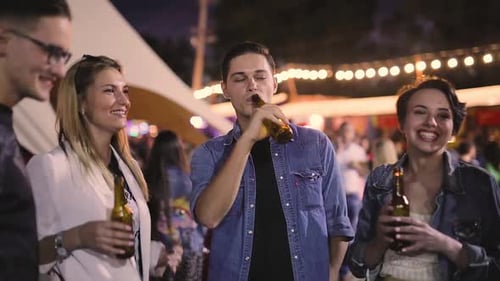 Young Adults Enjoying Time Together Outdoors at Night