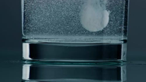 Effervescent Tablet Dissolving in Glass of Water