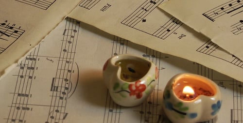 Antique Music Sheet with Candlelight