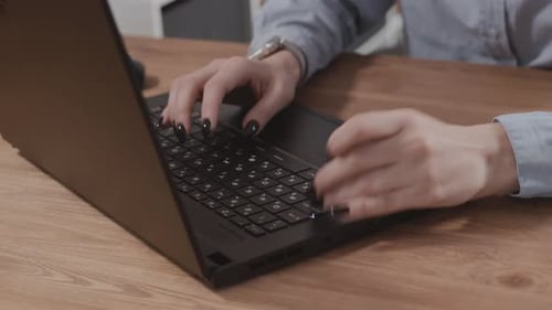 Woman Typing on Laptop Keyboard in Home Office