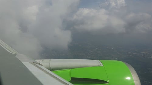 Scenic Flight Above City, Bright Green Airplane Engine