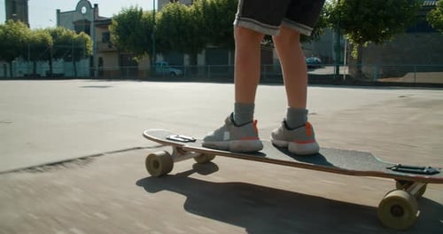 Children Legs Close Up Ride on Skate Longboard Leads Active Lifestyle and Sport