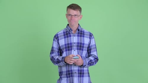 Man in Plaid Shirt Using Mobile Phone