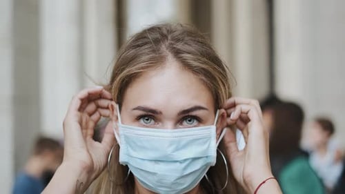 Girl Put Masks Closeup Corona Virus. Crowded Street People Covid-19. Look Woman