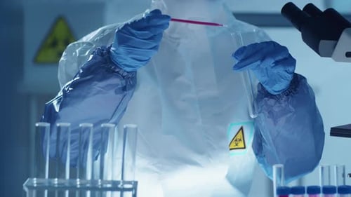 Scientist Mixing Liquids in Lab for Research