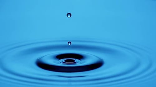Liquid Drop Creating Ripples in Cerulean Blue