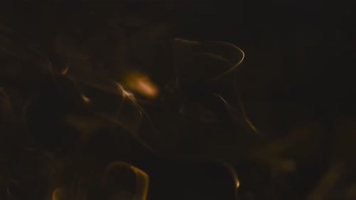 Abstract Swirling Orange Smoke on Black Background