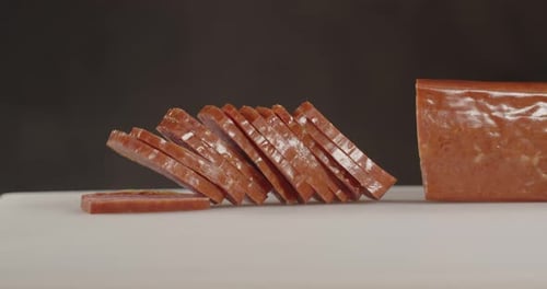 Slicing Meat. With A Sharp Knife Cuts Thin Slices Of Sausage.