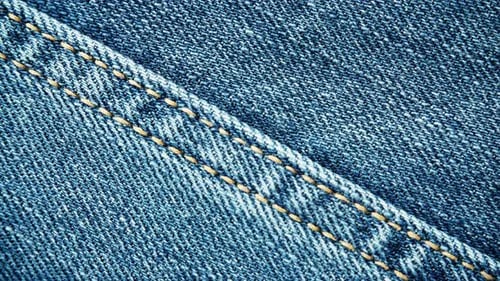 Detailed Close-Up of Blue Denim Fabric and Stitching