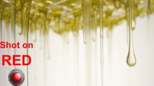 Oil Drops Pouring Down From Top In Slow Motion Shot On Red And Laowa On White Background