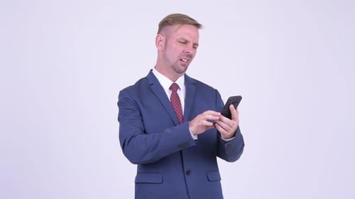 Man in Suit Frustrated with Cell Phone