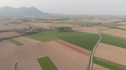Aerial view: tractor working on cultivated fields