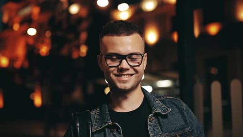 Smiling Young Adult in Urban Setting at Night
