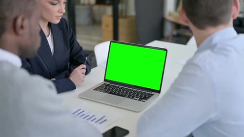 Rear View of Business People Using Laptop with Green Chroma Screen