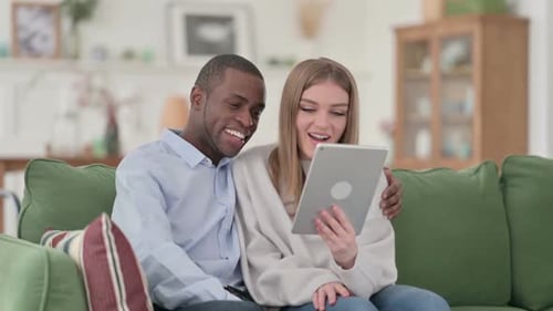Couple Video Chatting on Tablet at Home
