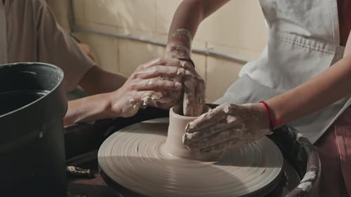 Hands Molding Clay on Pottery Wheel Close Up