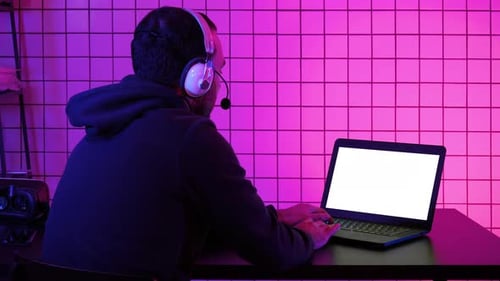 Professional Gamer Playing Video Game on His Laptop