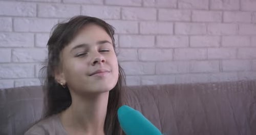 Girl Using Hairdryer at Home