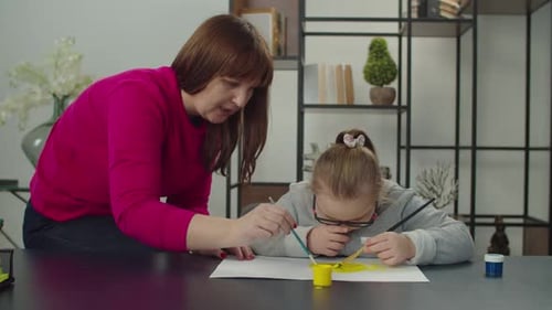 Woman and Child Painting Together at Home
