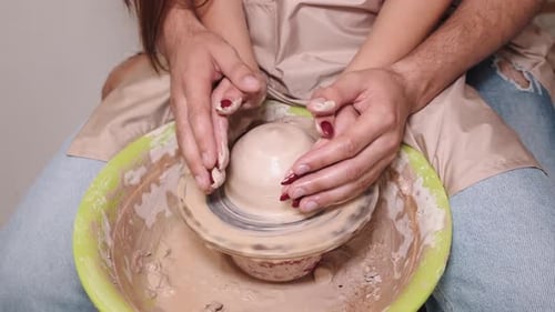 Couple Hands Making a Pot on a Pottery Workshop