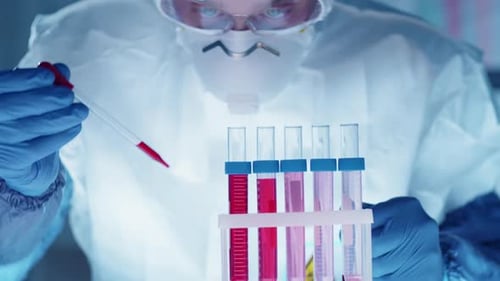 Scientist Analyzing Red Liquid in Petri Dish