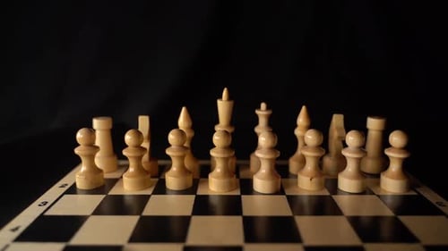 White Wooden Pieces on a Chessboard