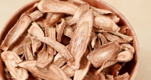 Dried Burdock Root Slices in Wooden Bowl