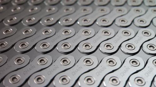 Worn out steel bicycle chain laid down tightly in an endless pattern. 4KHD
