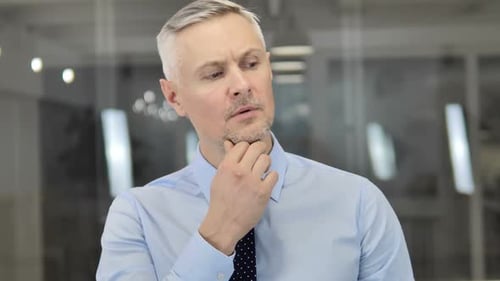 Thinking Grey Hair Businessman in Office Brainstorming